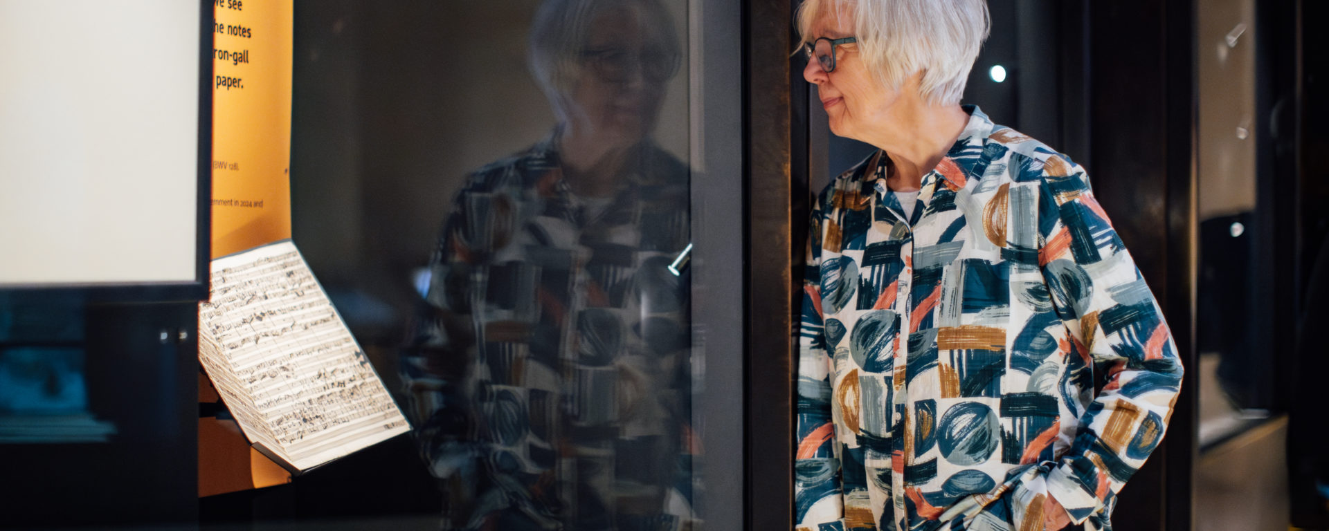 Composer Judith Weir looking at the manuscript in the Weston Library;.